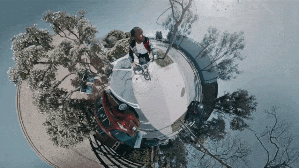 Kendrick riding a bike on a tiny planet (filter)